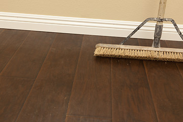 Image showing Push Broom on a Newly Installed Laminate Floor and Baseboard