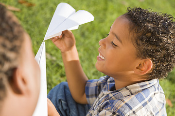 Image showing Mixed Race Father and Son Playing with Paper Airplanes