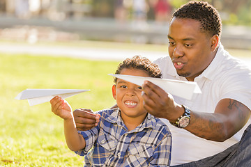 Image showing Mixed Race Father and Son Playing with Paper Airplanes