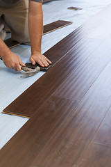 Image showing Man Installing New Laminate Wood Flooring