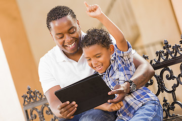 Image showing Mixed Race Father and Son Using Touch Pad Computer Tablet