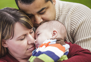 Image showing Happy Mixed Race Parents Hugging Their Son