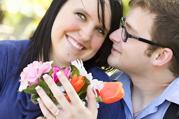 Image showing Attractive Young Man Gives Flowers to His Love