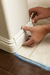 Image showing Contractor Installing New Baseboard with Bull Nose Corners and N