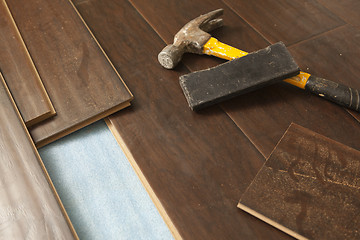 Image showing Hammer and Block with New Laminate Flooring