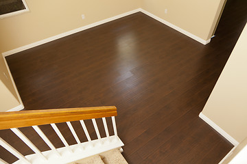 Image showing Newly Installed Brown Laminate Flooring and Baseboards in Home