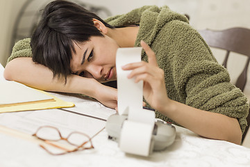 Image showing Mixed Race Young Female Agonizing Over Financial Calculations