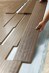 Image showing Man Installing New Laminate Wood Flooring