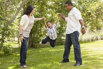 Image showing Hispanic Mother and Father Swinging Son in the Park