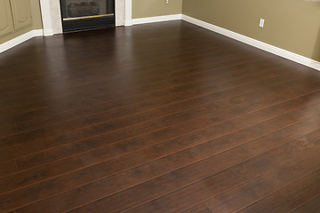 Image showing Newly Installed Brown Laminate Flooring and Baseboards in Home