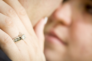 Image showing Female Hand with Engagement Ring Touching Fiance's Face