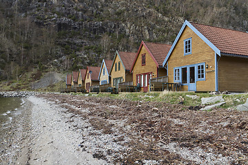 Image showing small holiday homes at coastline in norway