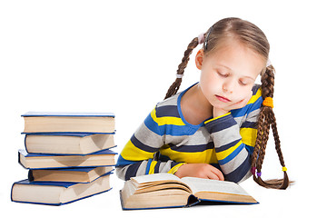 Image showing schoolgirl  sleeping over the book on isolated white