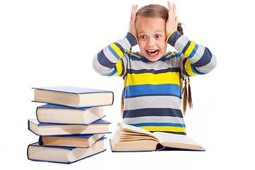 Image showing schoolgirl with horror looking at pile of books on isolated white