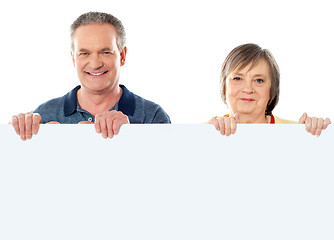 Image showing Old age couple holding blank banner ad