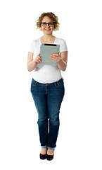 Image showing Full length of pretty woman holding tablet pc