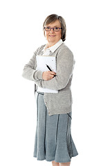 Image showing Senior woman holding spiral notepad and pen