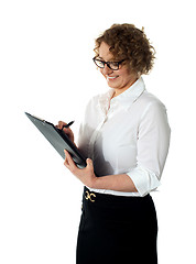 Image showing Female secretary writing business document