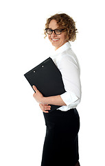 Image showing Smiling corporate woman posing with clipboard