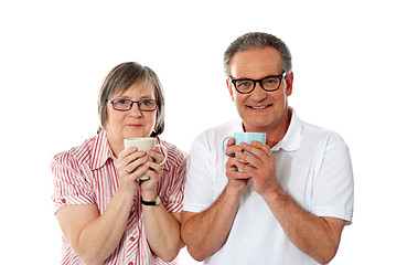 Image showing Romantic senior couple holding coffee mugs