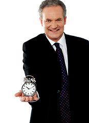 Image showing Corporate man showing alarm clock