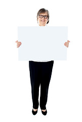 Image showing Senior female executive showing advertising board