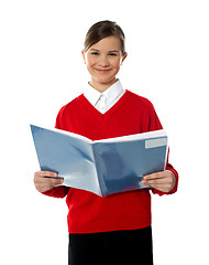 Image showing Charming school kid reading book