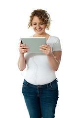 Image showing Techy senior woman enjoying music