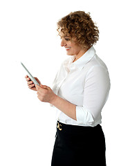 Image showing Smiling businesswoman looking at tablet pc