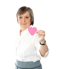 Image showing Woman showing heart shaped pink paper