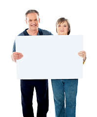 Image showing Husband and wife displaying advertising board