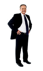 Image showing Senior businessman posing with hands on his waist
