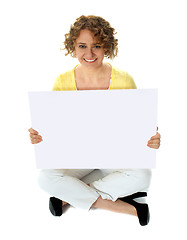 Image showing Isolated woman holding blank banner ad