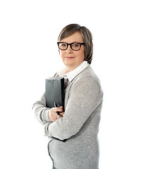 Image showing Aged woman holding business documents