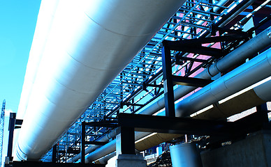 Image showing Industrial zone, Steel pipelines and valves against blue sky