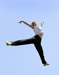 Image showing Happy woman jumping high