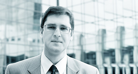 Image showing Young businessman in front of the office building