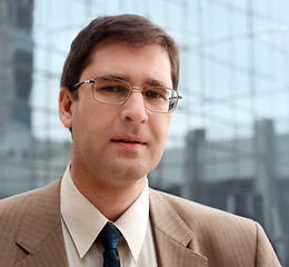 Image showing Young businessman in front of the office building