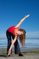 Image showing girl doing morning exercises at the beach 