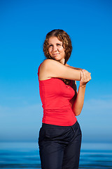 Image showing girl doing morning exercises at the beach