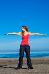 Image showing girl doing morning exercises at the beach