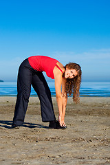 Image showing girl doing morning exercises at the beach