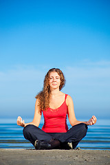 Image showing girl doing morning exercises at the beach