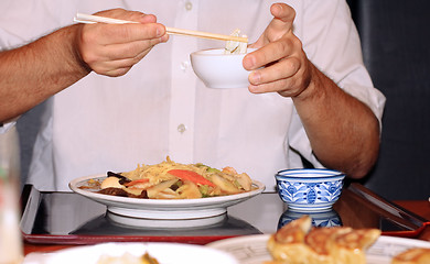 Image showing Eating with chopsticks