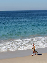 Image showing Woman walking on the beach