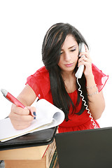 Image showing Busy businesswoman using mobile phone and take note