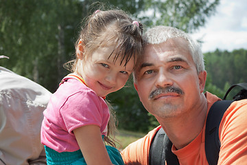 Image showing Grandfather and granddaughter out for a walk