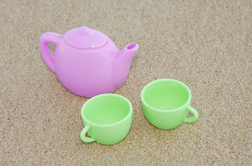 Image showing Toy cups on the sand