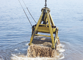 Image showing Floating crane scoops soil