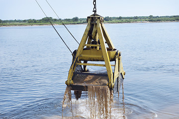 Image showing Floating crane scoops soil
